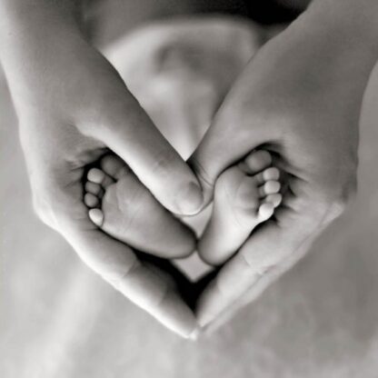 Baby feet in hands greetings card